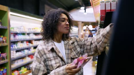 curly woman reads ingredients on packs, buying products and shopping