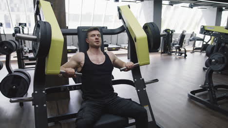 exercises and sport workout at gym. fit and muscular athlete actively training in the modern gym