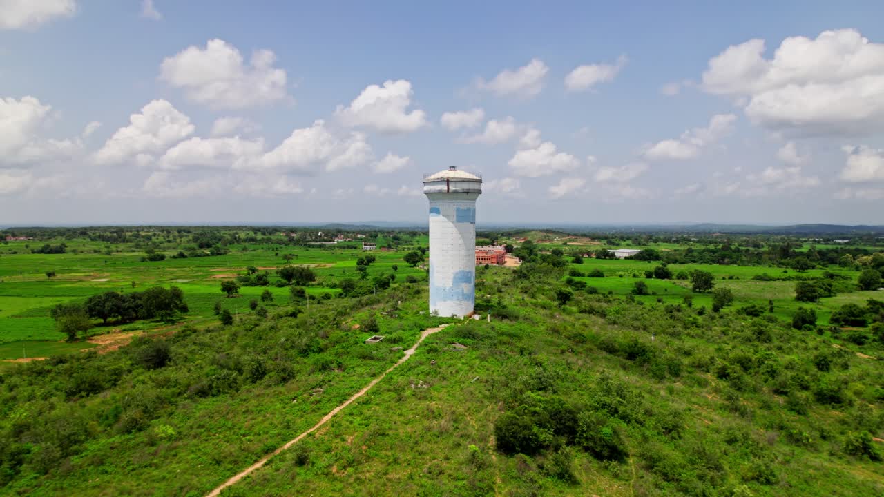 big size of water tank with greenery, sky and clouds at tekmal village, medak district, telangana, india. day time, drone shot, 4k.