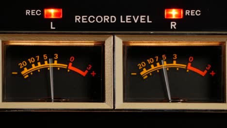 analog vu meter of a vintage tape recorder machine while recording