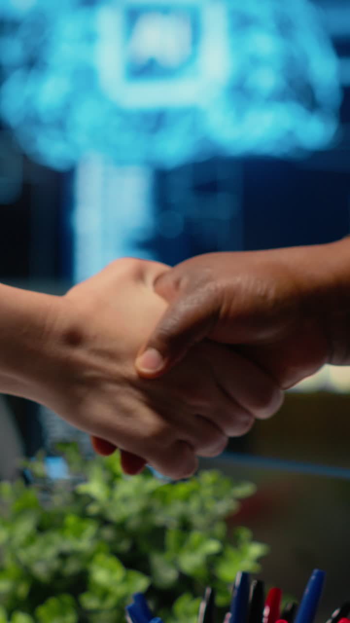 Vertical video Programmer shaking hand with businessmen in tech agency ...