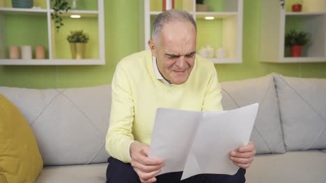 Retired-old-man-reading-bad-notice,-medical-report,-bank-papers-is-surprised-and-frustrated.