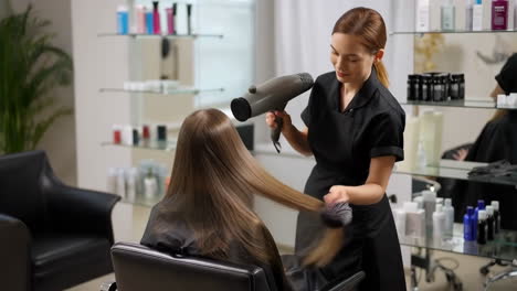 hairdresser styling client's hair in a beauty salon