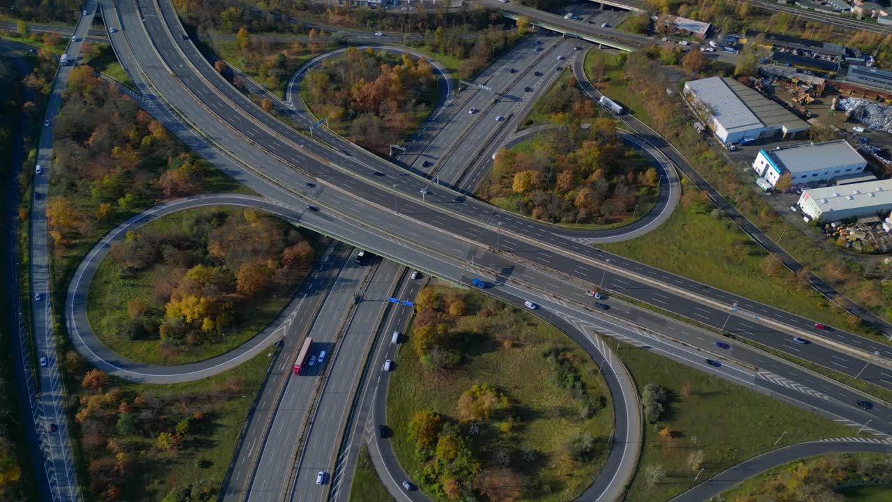 Complex highway interchange with cars traversing roads in Berlin. Bird's eye view drone camera pointing down. Tremendous aerial view flight drone camera pointing down