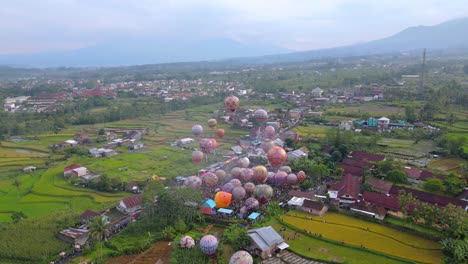 aerial view of colorful air balloon floating on the air with view of rural landscape