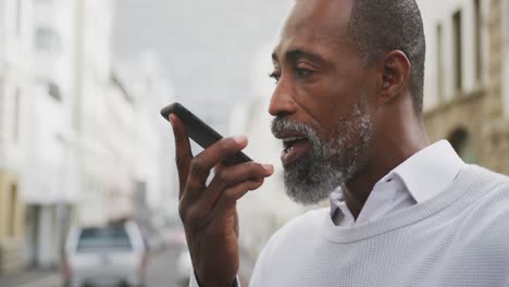 african american man using his phone in the street