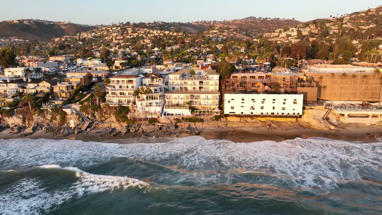 Luxury Beachfront Real Estate In Laguna Beach, California (USA). Offshore Aerial Pan Across Multi-Million Dollar Cliffside Properties Overlooking The Pacific Ocean.