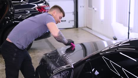 man covering car with vinyl polyurethane tape. films for the car. sticker protective film on the car