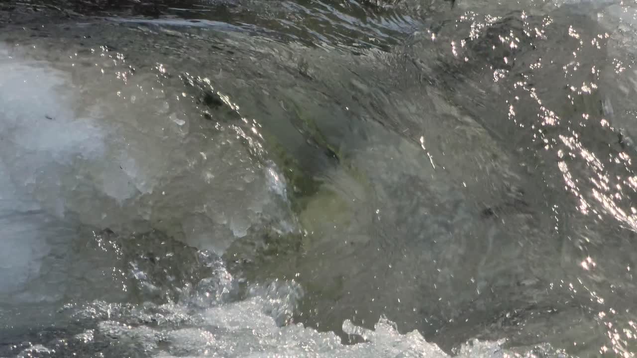 Clear Water Flowing Through Ice And Snow At Hoggs Falls During Winter In Flesherton, Ontario, Canada