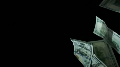 falling flying american canadian dollar banknotes on a black background in 4k loopable. high quality falling dollar banknotes in 4k. video is loopable