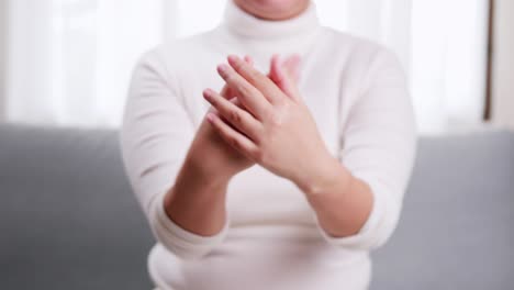 detail of young woman performing moisturizing hand with moisturizer lotion in cream