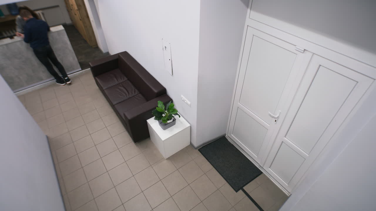 Modern office lobby with waiting area and reception desk