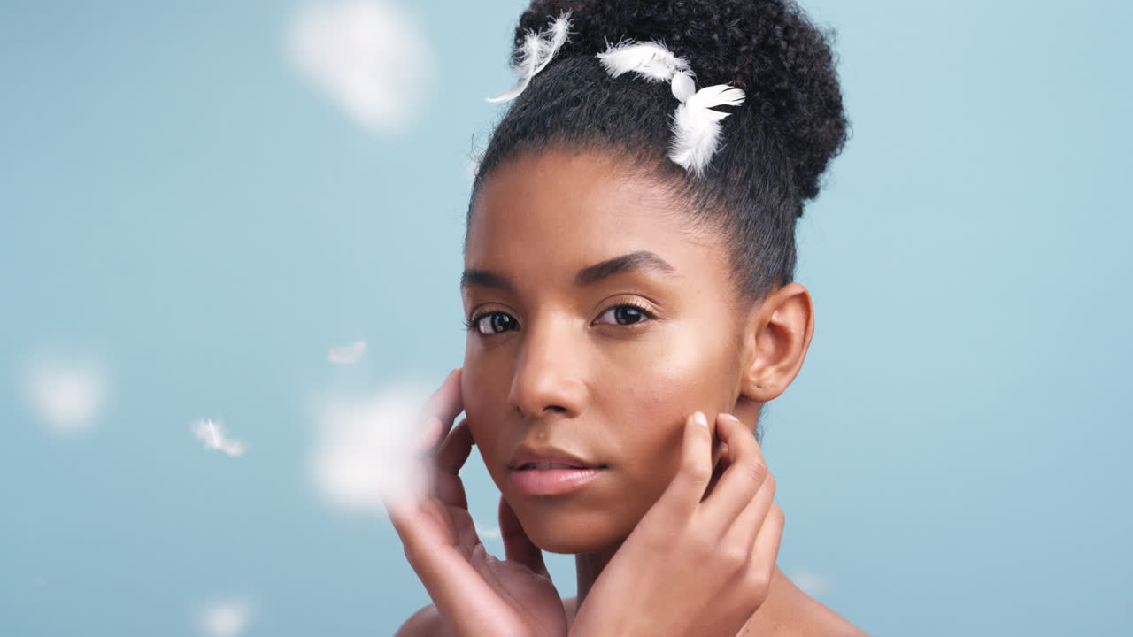 Soft feathers falling on a beautiful African woman