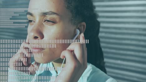 Music-equalizer-against-close-up-of-african-american-woman-wearing-earphones