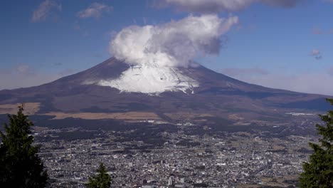 locked off view over gotemba city at bottom of snowy mount fuji on clear day