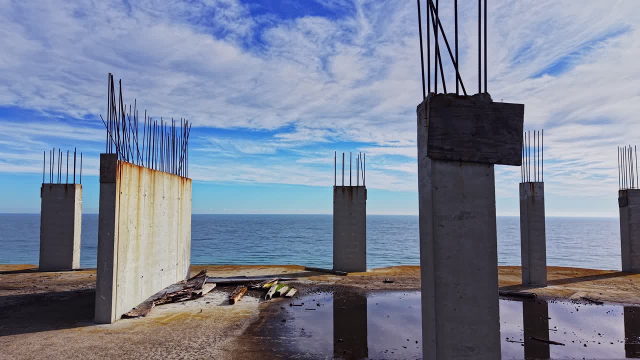 Coastal construction site overlooking the serene ocean view at midday