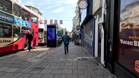 pedestrian walking past bus on city street