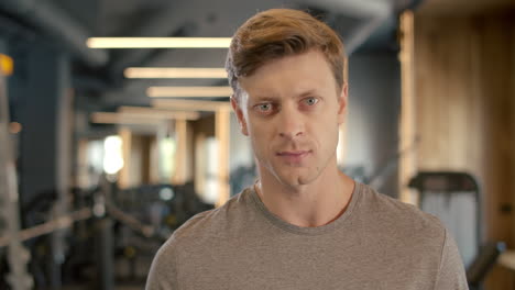 sportsman standing in sport club. portrait of handsome bodybuilder at gym.