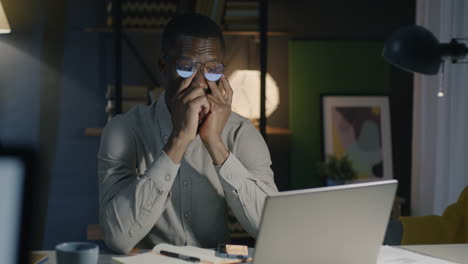 tired businessman working late at night