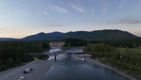 camping vehicles parked on the banks of middle fork flathead river near blankenship bridge in columbia falls, montana