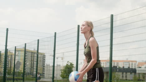 side view of blonde woman hitting a volleyball