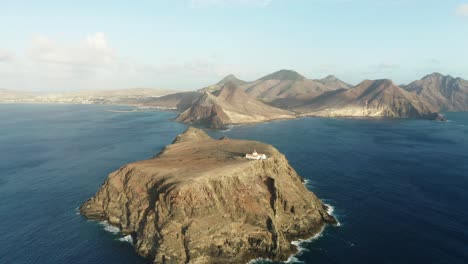 volcanic island ilhéu de cima with lighthouse off coast of porto santo