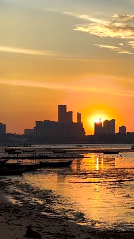 sunset view with boats and city skyline
