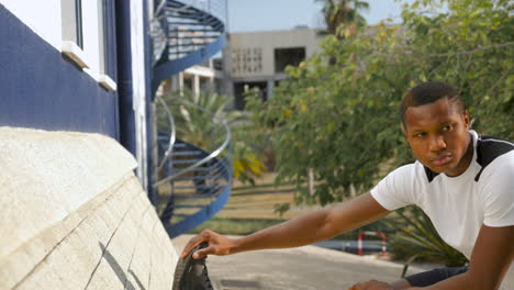 young black man stretching before running outdoors with copy space