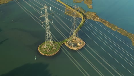 electric power lines and pylon towers on river test in southampton, uk