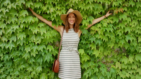 woman with straw hat, smiling in a garden