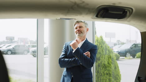 businessman viewing a car in a showroom