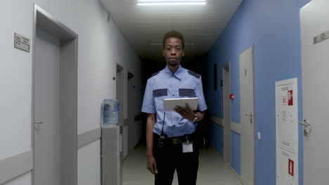 man in uniform posing on the corridor