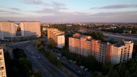 Aerial-rising-over-Cracow-city-downtown-at-sunrise-revealing-an-amazing-skyline-with-purple-clouds