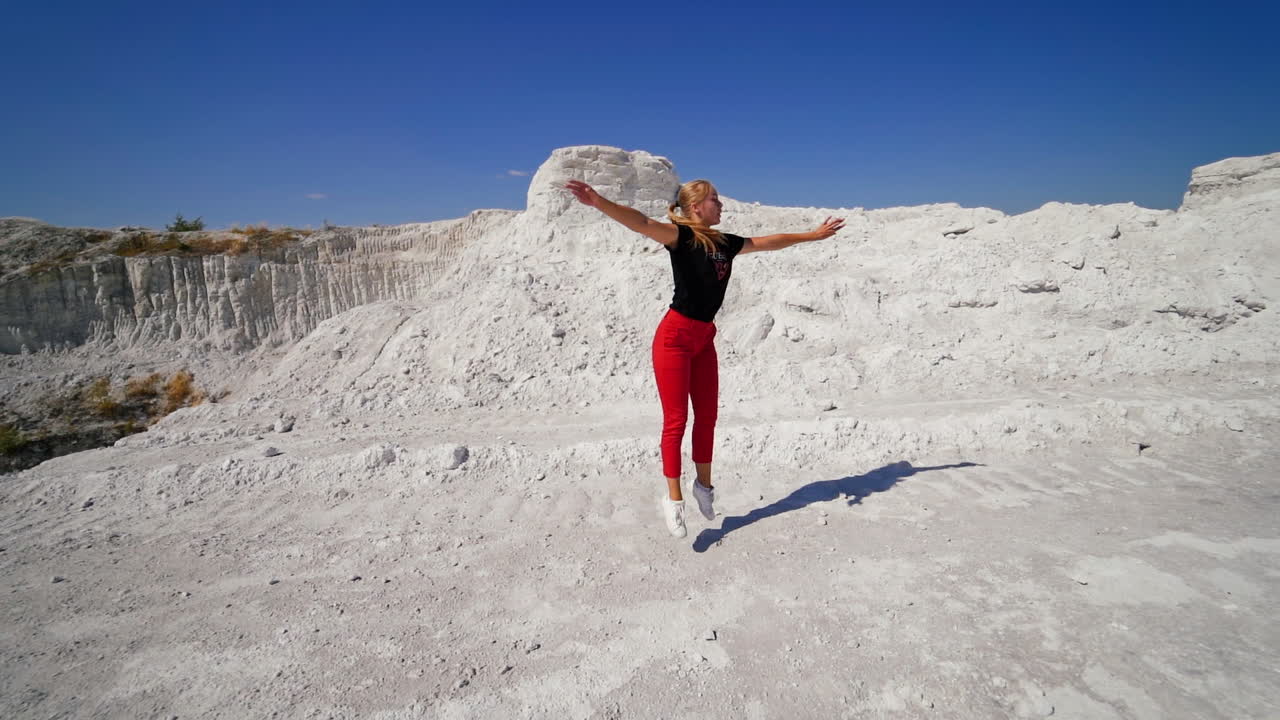 Dancer performing in a quarry landscape