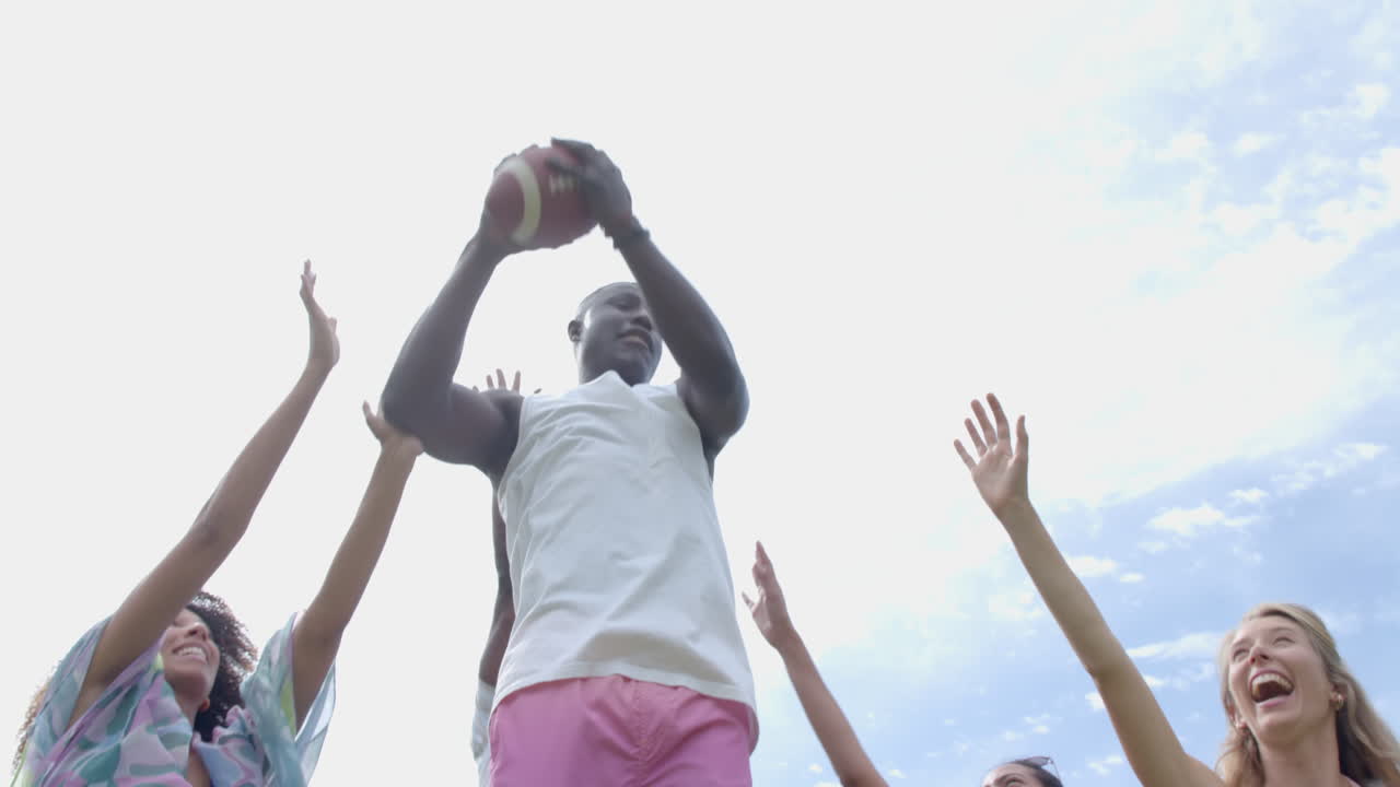 Young African American man plays basketball outdoors with copy space