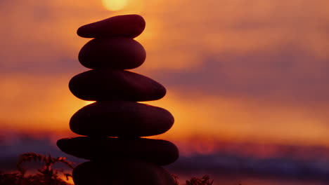 a tower of stones falls from a blow destruction concept