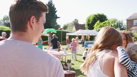 slow motion shot of busy cake stall at summer garden fete