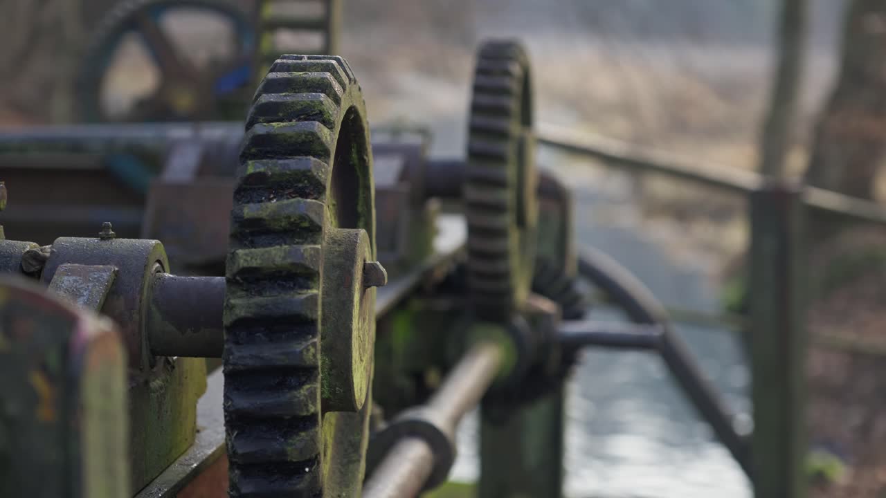 Old weathered Metal Cog Wheel mechanism on Abandoned River Sluice close-up
