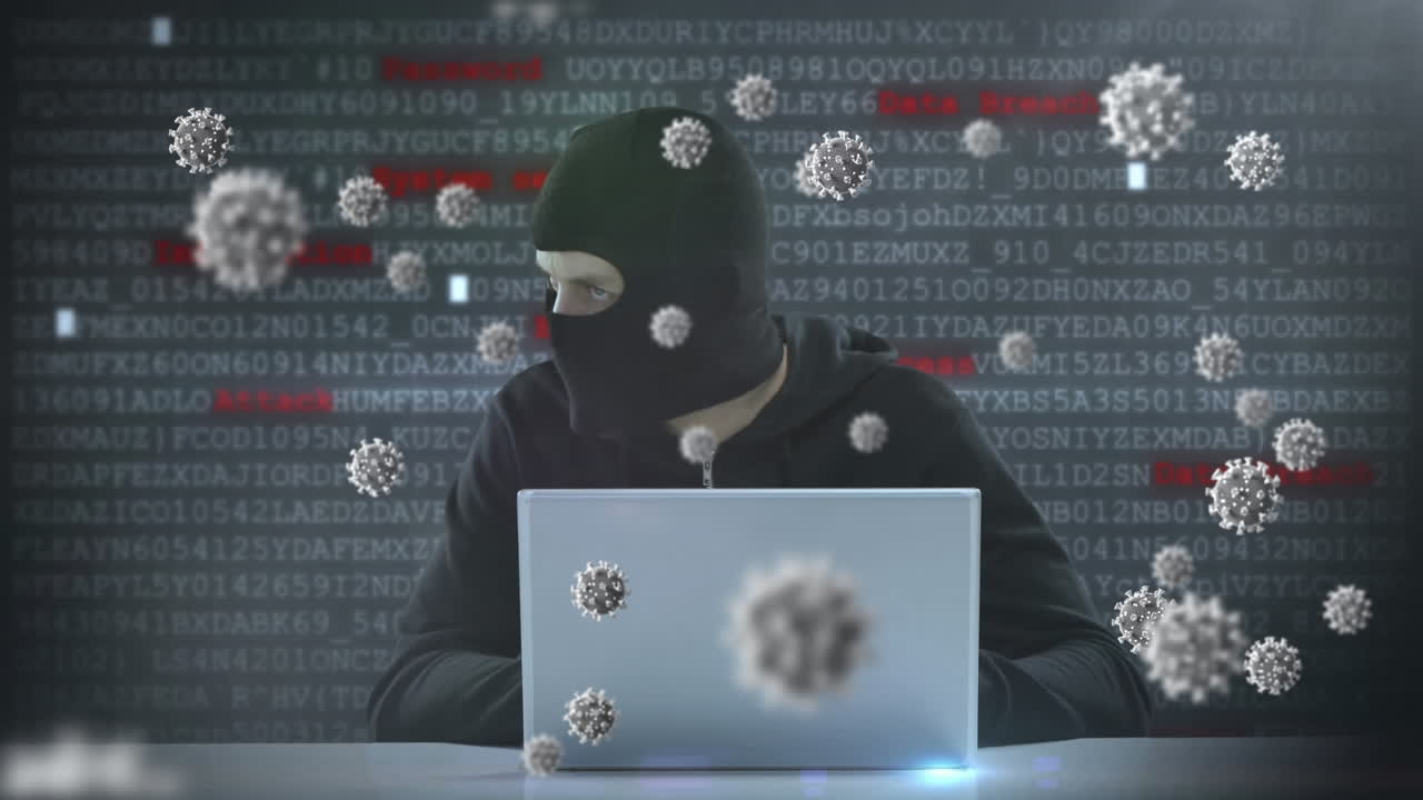 animazione di macro cellule di covid19 su un uomo che indossa una balaclava, usando un portatile
