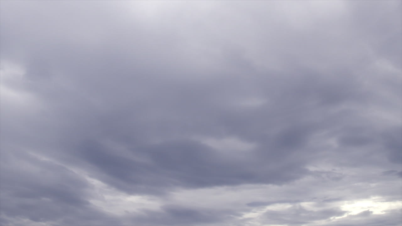 Time Lapse: Stormy white and grey clouds moving across the sky