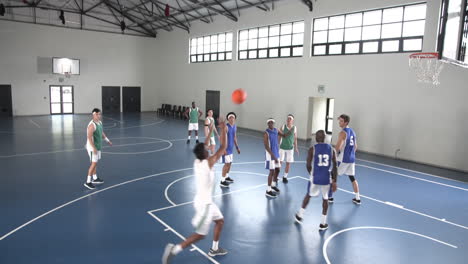 basketball players practicing teamwork on indoor court, preparing for game