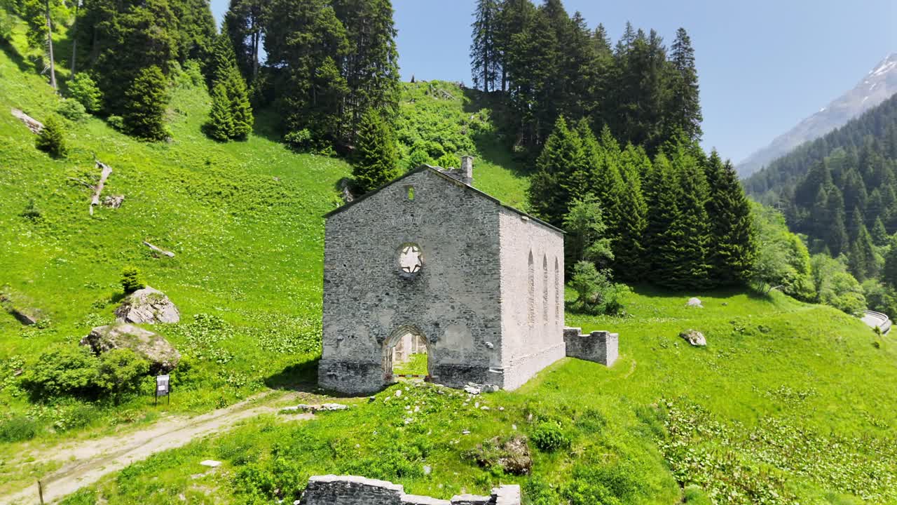 Ruins of San Gaudenzio church, Casaccia, Bregaglia, Swiss Alps, Switzerland. Aerial drone ascending