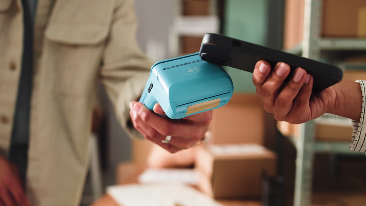Customer Making Contactless Payment with Smartphone at Payment Terminal