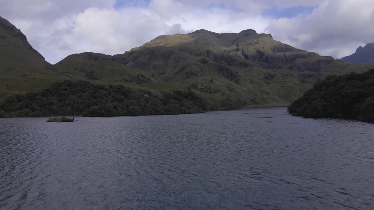 Serene Lake Surrounded by Lush Green Mountains