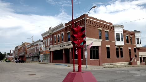 antique four way stop light and buildings in downtown toledo, iowa with stable video close up at an angle