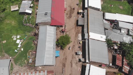 aerial zenith drone shot of a main road splitting up two zones of houses in uganda, africa