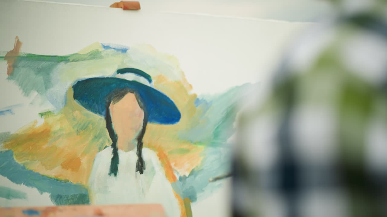 A handicrafter wearing a checkered shirt, face not visible, skillfully paints a colorful portrait on a canvas. the artist's focused creativity, with vibrant strokes bringing the artwork to life