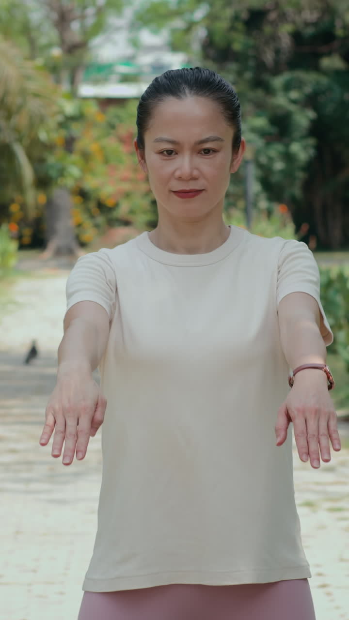 Vertical of Adult Female Athlete Doing Circular Movements with Arms