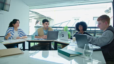 young coworkers discussing business papers on meeting in the office
