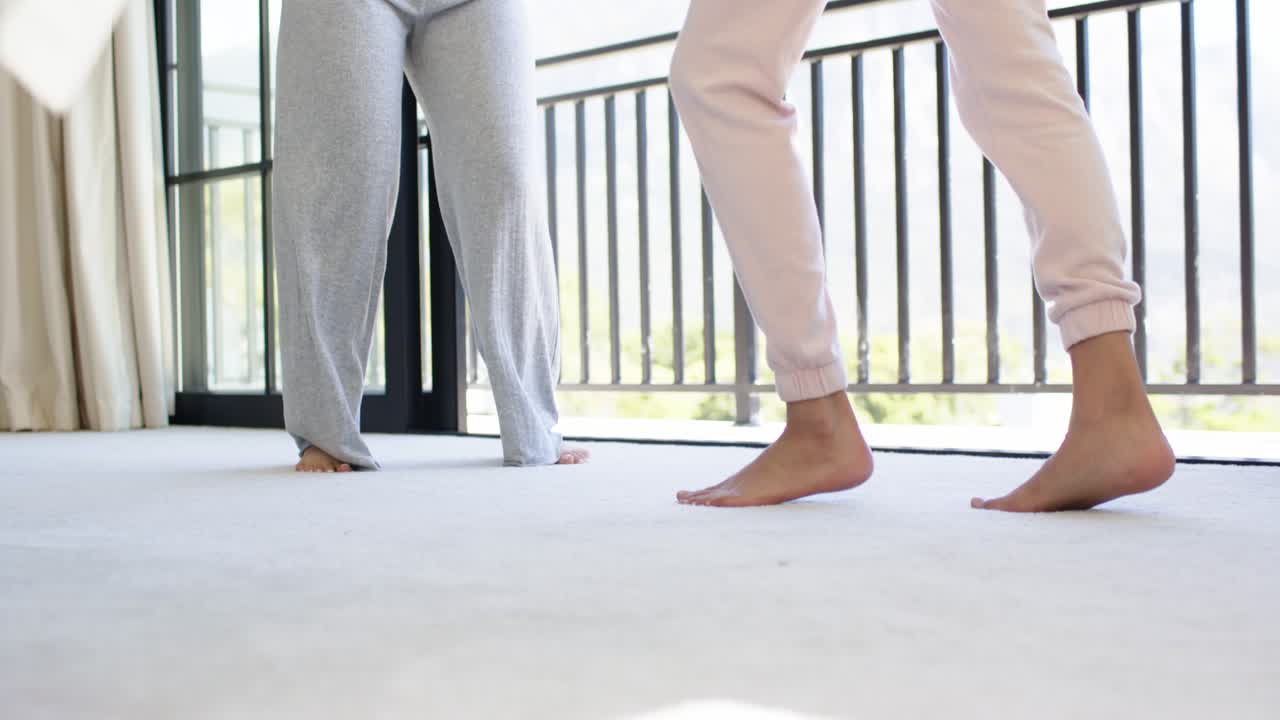 Diverse female friends in pants starting together stepping and lifting heels practicing on carpet